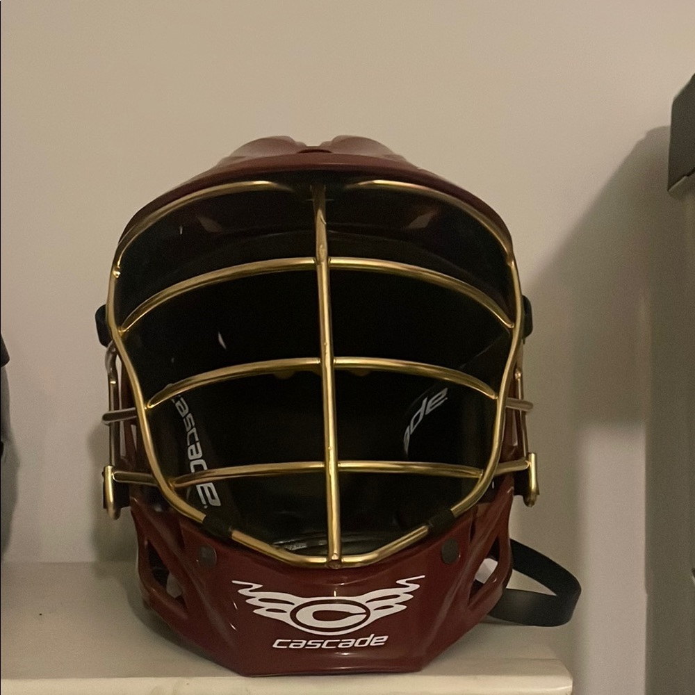 Maroon Lacrosse Helmet with Gold Cage